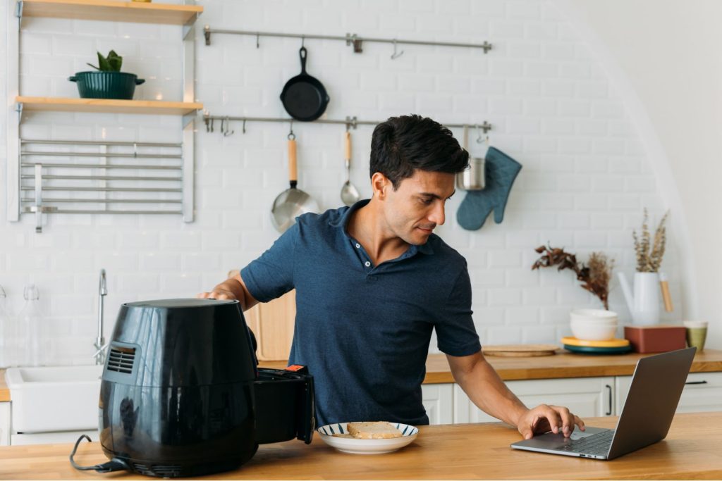 man using air fryer